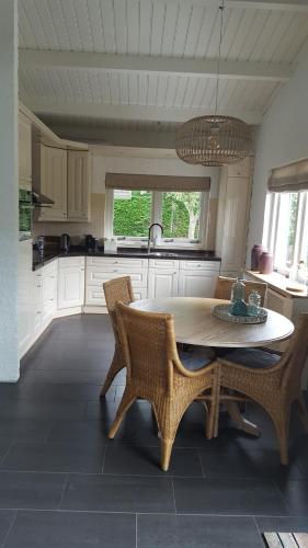 a kitchen with a table and chairs in a room at Zee en Meer in Kamperland