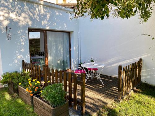 a backyard patio with a table and a table at Bed & Breakfast Wine & Cooking Penedès in Pla del Panadés