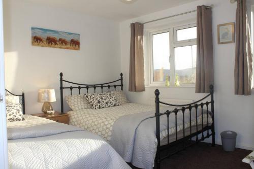 a bedroom with two beds and a window at Shirebrook House Coventry west Midlands in Coventry