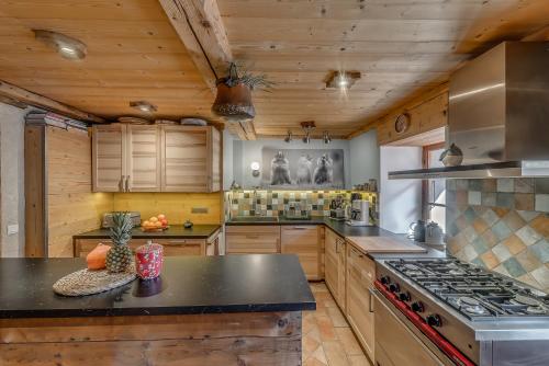 a large kitchen with wooden cabinets and a stove at Colettine in Tignes