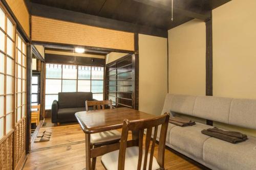 a living room with a table and a couch at Sanjo Iho-an in Kyoto