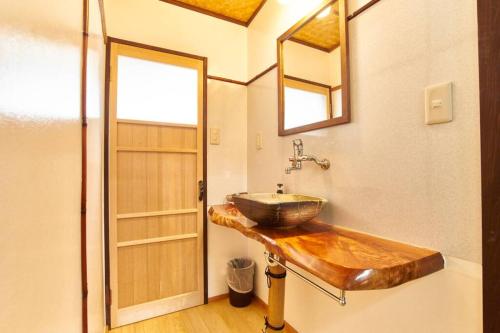 baño con lavabo de madera en la pared en Koke-an, en Kioto