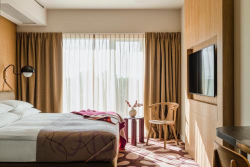 Una cama o camas en una habitación de PURO Kraków Stare Miasto