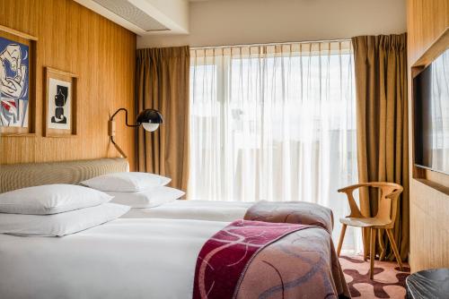 Una cama o camas en una habitación de PURO Kraków Stare Miasto