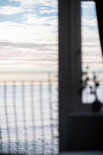 a view of the ocean through a window at The Elizabeth in Sidmouth