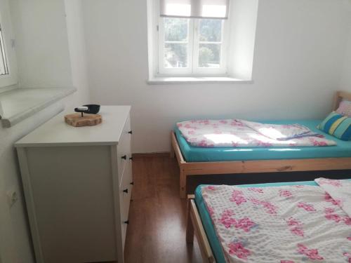 a room with two beds and a counter and a table at Land Wohnung in Gratkorn