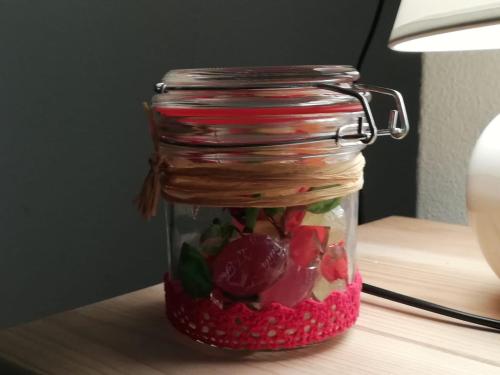 a glass jar filled with fruits and vegetables on a table at Land Wohnung in Gratkorn