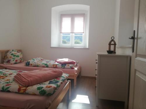 a room with three beds and a window at Land Wohnung in Gratkorn