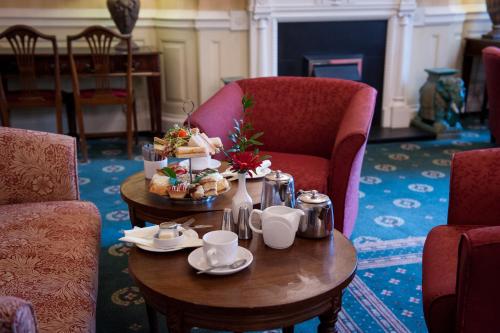 a room with a table with a tray of food on it at Hydro Hotel in Eastbourne