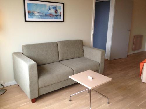 a living room with a couch and a table at Hotel Marina in Vedbæk