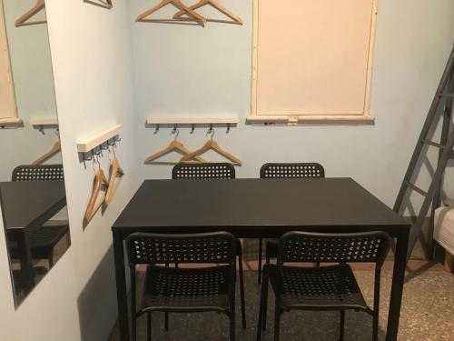 a dining room with a black table and chairs at Happy Taipei Hostel - Share House - Monthly in Taipei