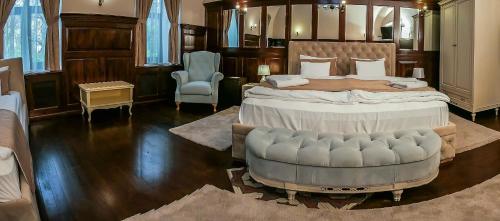 a large bedroom with a large bed and a chair at Belga Boutique Panzió in Debrecen