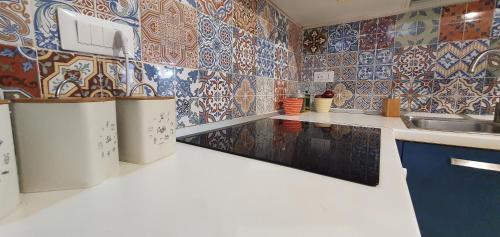 a kitchen with colorful tiles on the wall at Villa Cappero in Santa Marina Salina