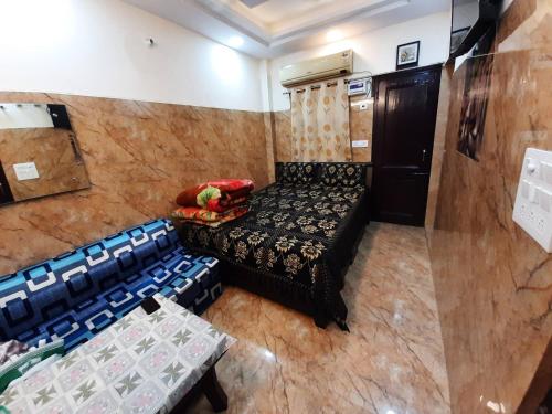 a small room with a bed and chairs in it at Cream Location,wifi With Android Tv, Luxury Room in New Delhi