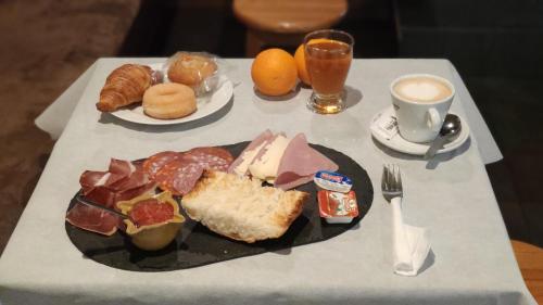 a table with a plate of food and a cup of coffee at Hotel Teruel Plaza in Teruel