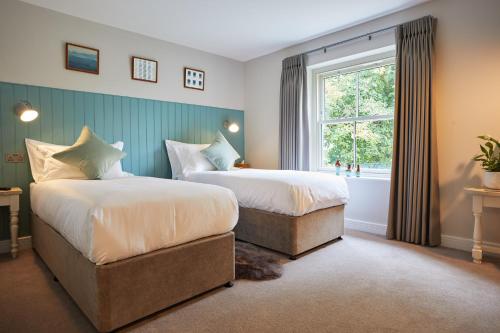 A bed or beds in a room at The Lime Tree Inn