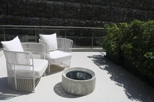 a group of chairs and a fire pit on a patio at LBV House Hotel in Pinhão