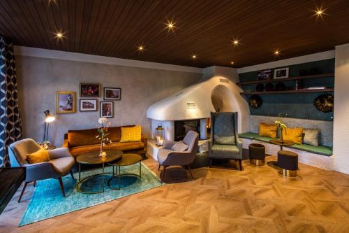 a living room filled with furniture and a fireplace at Hofgut Algertshausen in Eresing