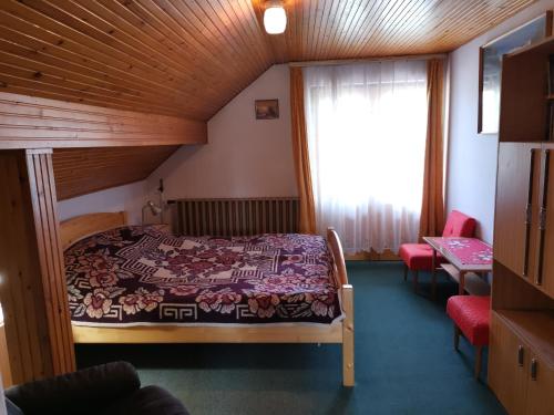 a bedroom with a bed in a room with a window at Anna Ház in Balatonkeresztúr