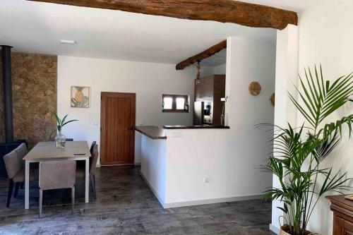 a kitchen and dining room with a table and a counter at Casa Mira Tâmega in Marco de Canaveses