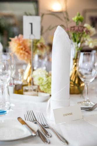 a table with silverware and a white paper napkin at Hofgut Algertshausen in Eresing