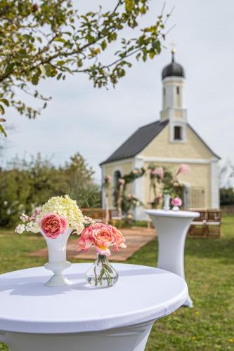 two vases on a table with a lighthouse in the background at Hofgut Algertshausen in Eresing