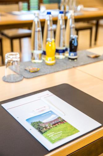 a tablet on top of a table with glasses at Hofgut Algertshausen in Eresing