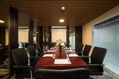 a conference room with a long table and chairs at Soleil Boutique Hotel Hanoi in Hanoi