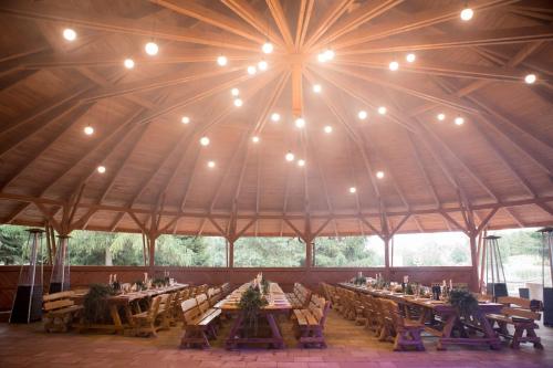 a large tent with tables and chairs in it at Hotel Trzy Podkowy*** in Biskupiec