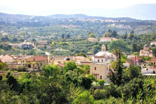 a view of a town with trees and buildings at Villa Philia Archontiko in Gavalochori