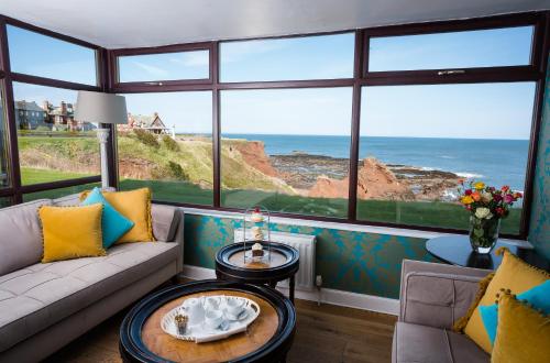 a living room with a view of the ocean at Bayswell Park Hotel in Dunbar