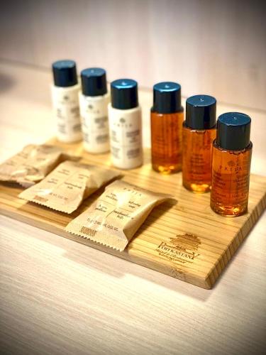 a group of four bottles of honey on a wooden board at Hotel & Restaurant Pod Kaštany in Krupka - Marsov