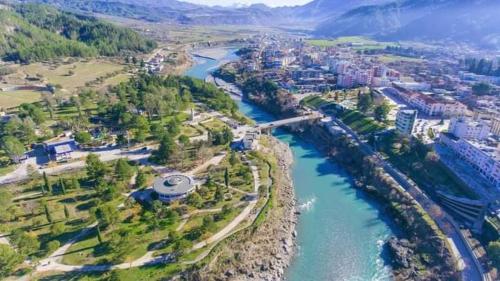 an aerial view of a river and a city at Eagle house in Përmet
