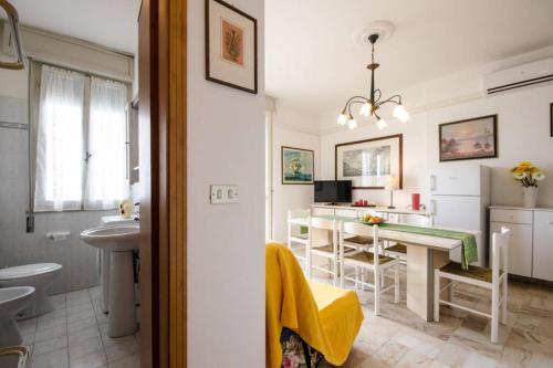 a bathroom with a sink and a table in a room at Cortina 1-83 in Lido di Pomposa