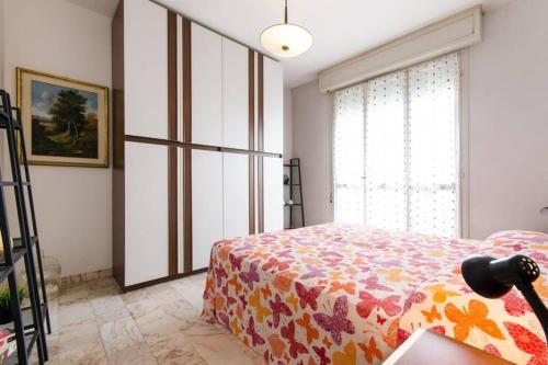a bedroom with a bed and a window at Cortina 1-83 in Lido di Pomposa