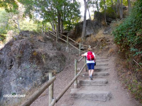 a woman walking up a set of stairs at Casa rural Los Abuelos in Monachil