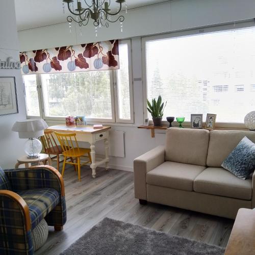 a living room with a couch and a table at Torni-Mänttä in Mänttä