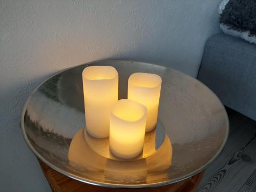 three candles sitting on top of a glass table at Torni-Mänttä in Mänttä