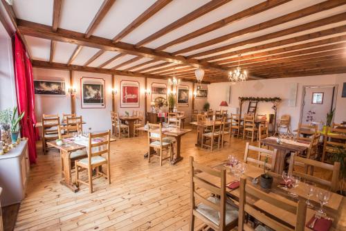 un restaurant avec des tables et des chaises dans une salle dans l'établissement Auberge le Sabot de Vénus, à Méaudre