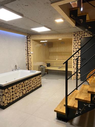 a large bathroom with a tub and a staircase at Chochołowskie Spanie in Chochołów