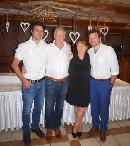 a group of three men and a woman posing for a picture at Bruggerhof in Fulpmes