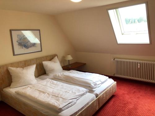 a bedroom with two beds with white sheets and a window at Ferienwohnung Hochschwarzwald in Hinterzarten