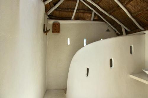 a room with white walls and a ceiling at Coco Tulum Zen Zone Hotel in Tulum