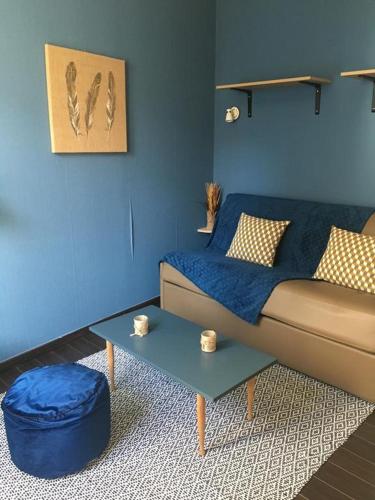 a living room with a couch and a table at La Vague in Yport