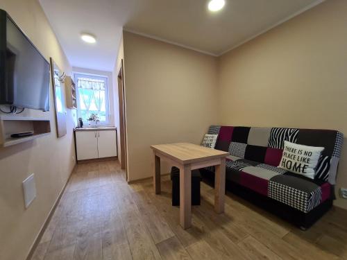a living room with a couch and a table at Stredisko Lipka in Bardejov