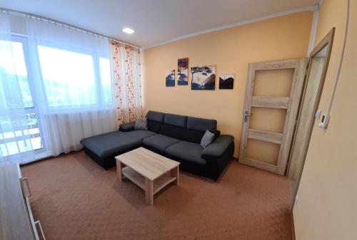 a living room with a couch and a table at Stredisko Lipka in Bardejov