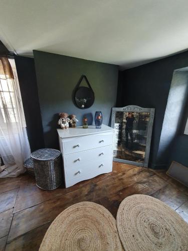 a room with a white dresser and a mirror at Au Nid de Caroline gîte 4 étoiles in Arette
