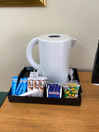 a tray with a coffee maker and a cup on a table at Paddle Steamer Motel in Swan Hill