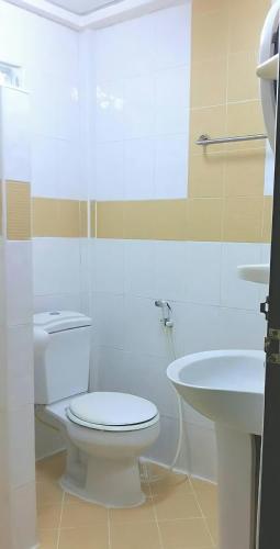 a bathroom with a toilet and a sink at ทรัพย์มุกดา แกรนด์ โฮเทล Submukda Grand Hotel in Mukdahan
