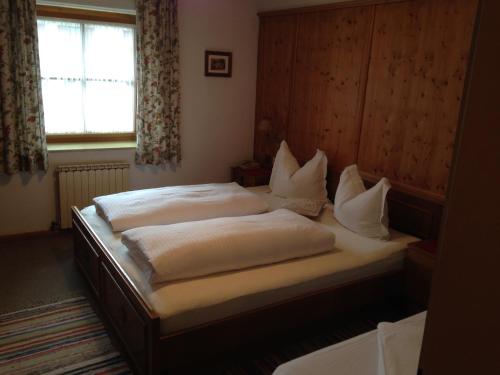 a bedroom with two beds and a window at Bichlhof in Ramsau im Zillertal